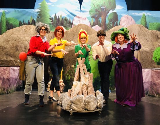 Darsteller des Bibi Blocksberg Musicals auf der Bühne, im Kreis stehend um ein Lagerfeuer.