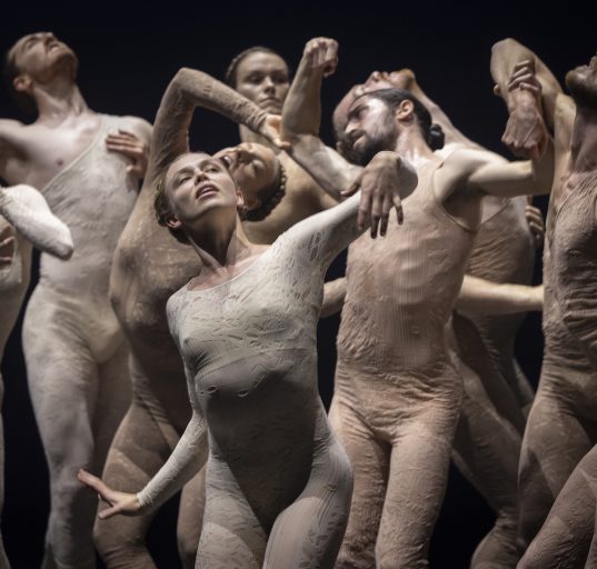 Tänzerinnen und Tänzer in schmutzig wirkenden Körpertrikots, eng beieinander tanzend in vielen verschiedenen Körperhaltungen. – SAABA von Sharon Eyal © Tilo Stengel