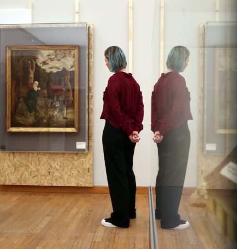 Frau betrachtet Dürrers "Flucht nach Ägypten" in der Ausstellung "Auf der Flucht"