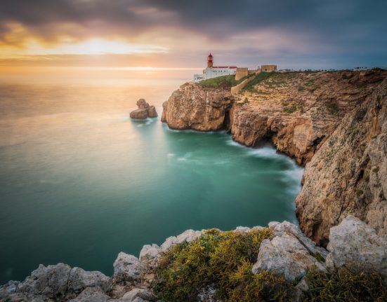 Künstelinie mit Leuchtturm bei Sonnenuntergang in Portugal